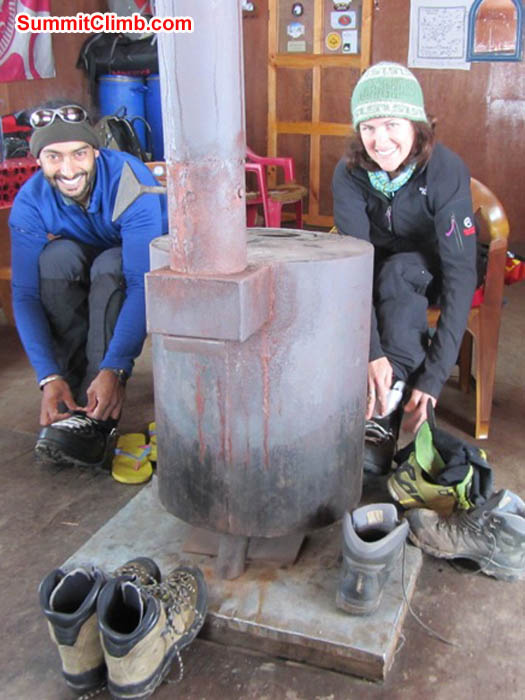 Saz and Maggie put on their climbing boots in the Mingbo Lodge. Photo by Mark van 't Hof