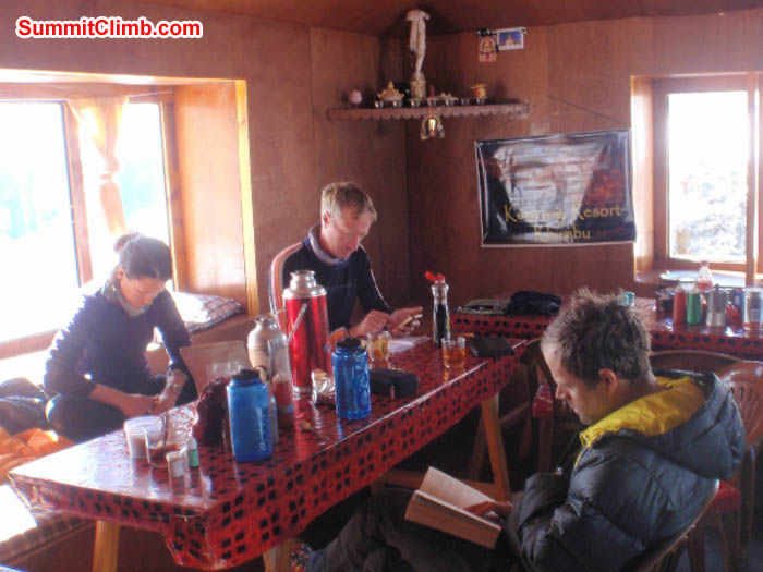 Maggie, Mark, and Tim reading in the Mingbo Lodge Dining Room, also known as 'our home'. James Barritt Photo.
