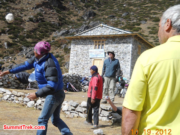 Joe, Stewart, and Sange watch Nawang Sherpa tossing a rock in the village lawn bowling competition in Tagnag at 4000 metres / 13,120 feet. Photo by Jennifer Klich.