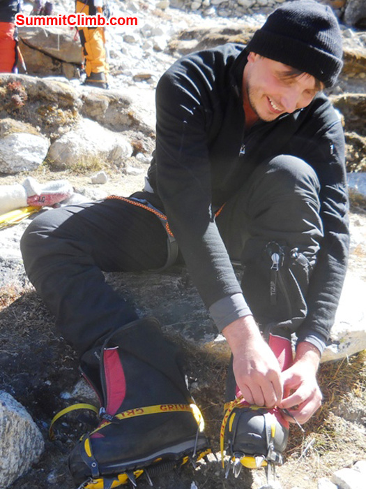 Frank puts on his crampons in Kare Village during a practice session. Photo by Jennifer Klich