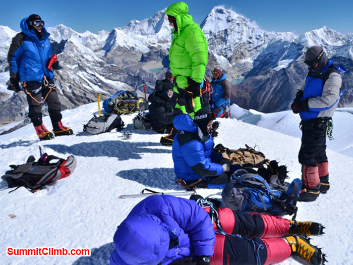 Mera Peak Team resting on the foresummit, before ascending final ropes to the top. It is a perfect sunny day with no wind. Photo by Michael Moritz.