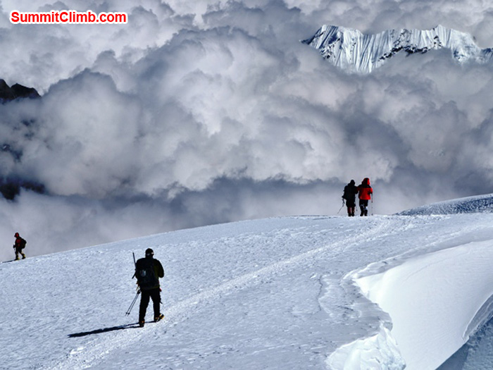 Climbers descending the zig zag trails past crevasses and clouds, coming down Mera Peak. Photo by Micheal Moritz.