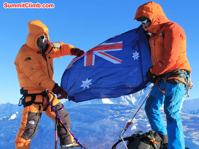 Summit Day of Mera Peak. Ray showing the his country flag with the help of Felix, Team leader. Photo Ray