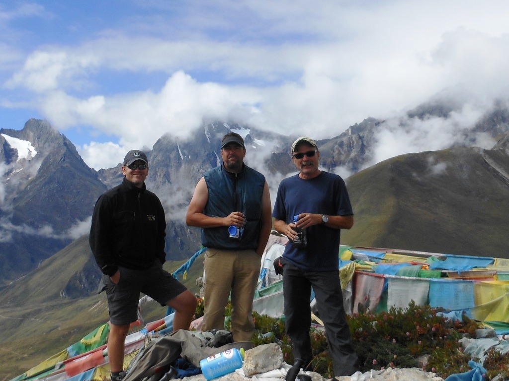 Troy, steve, and Kaley surrounded by peaks and prayer flags above Nyalam at 4375 metres - 14, 350 feet. Stu Frink Photo