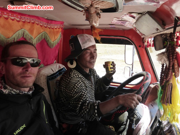 Juergen Landmann hitches a ride in a Japanese cargo truck while Hapa, the driver, sips a red bull. Dan Mazur Photo
