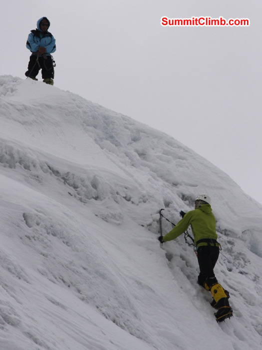 JJ climbs ice while Jangbu Sherpa instructs during ice trainng in ABC. Matti Sunell Photo
