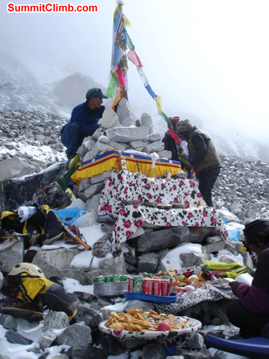 Stringing up prayer flags at the Puja basecamp blessing ceremony. Lama prays while all of the offerings are displayed beside himJames Grieve photo