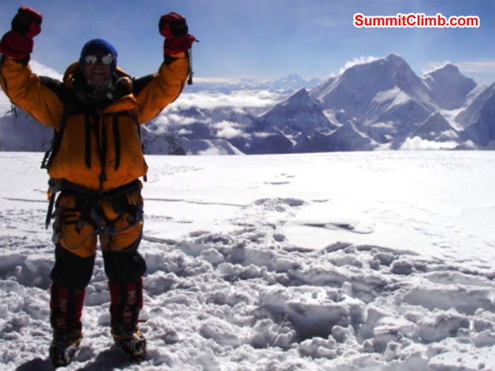 James Grieve on the summit. Everest Massif, including Nuptse and Lhotse in the background. Matt Olsen Photo