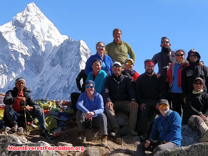 team members with mountain