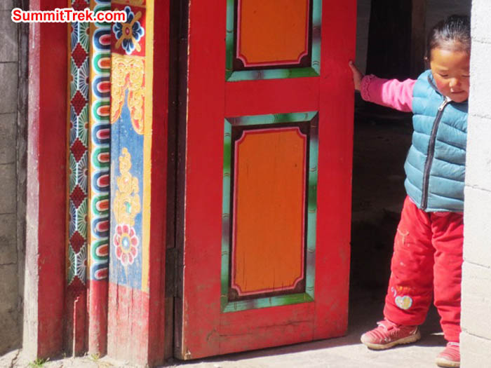 Cute little child in Pangboche plays with the temple doors. Hannah Rolfson Photo