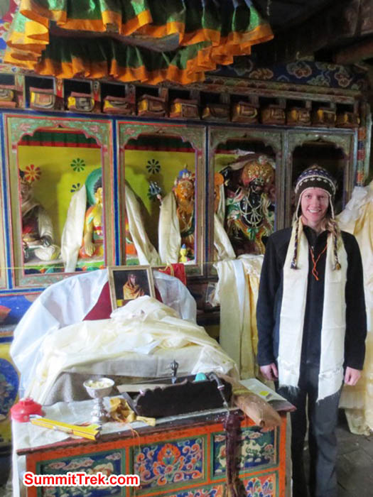 Hannah Rolfson beside the Pangboche Lama's throne and ceiling umbrella in Pangboche temple. Brian Rolfson Photo