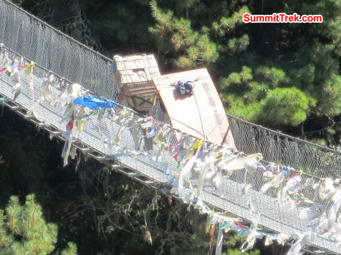 Lumber carriers on the suspension bridge to Namche. Photo Hannah Rolfson