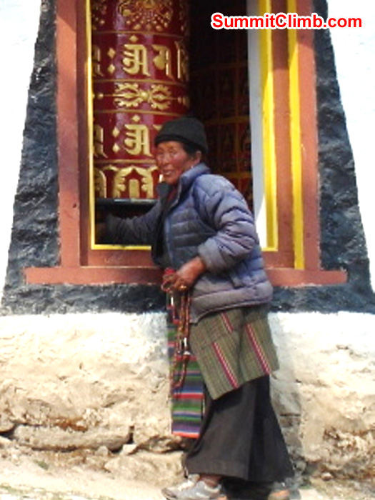 Sherpa Grandmother spins a prayer wheel in Tengboche Monastery. Monika Witkowska Photo.