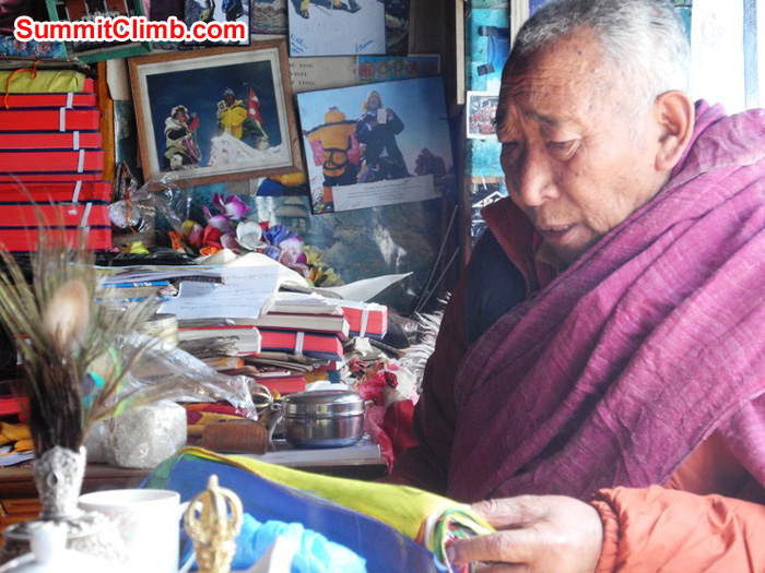 Pangboche's Lama Geshe reading the SummitClimb prayer flags during expedition blessing ceremony. Violetta Pontinen Photo.