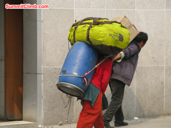 Porters carrying duffle bags and drums. This is the way we transport our expedition loads from Nepal side to China side. Photo Rares Voda