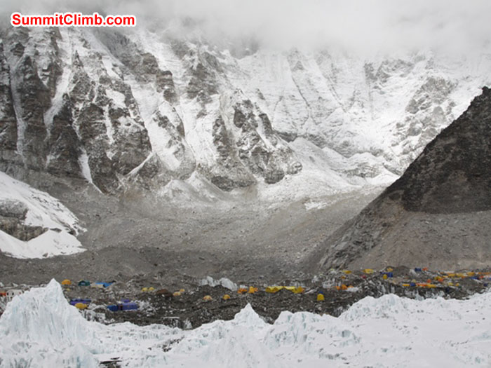 Everest basecamp nestles amongst the tall peaks and the Khumbu Glacier. See the line of glacial recession on the slopes on the right. Monika Witkowska Photo.