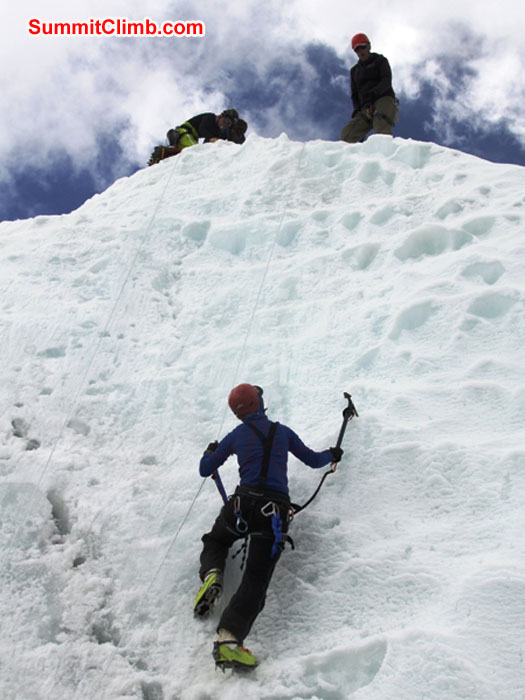 Sandra Grosskinsky climbs ice while Sange Sherpa and Anne-Mari look on. Monika Witkowska Photo.