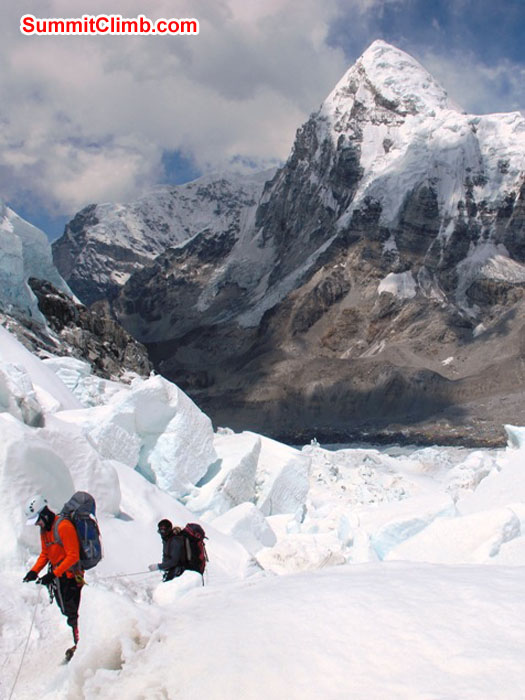 Chris Longacre and Sange navigating through the icefall one iceblock at a time. Mount Pumori looms behind. Monika Witkowska Photo