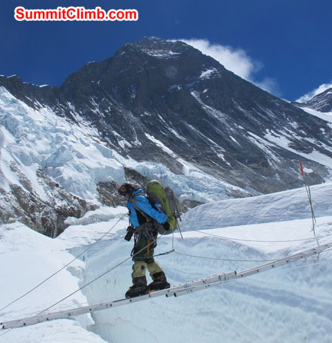 Jangbu Sherpa crosses a long ladder with Mt. Everest fully in the background. Monika Witkowska Photo