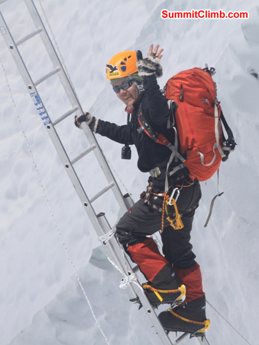 Monika Witkowska climbing a ladder in the icefall. Violetta Pontinen Photo