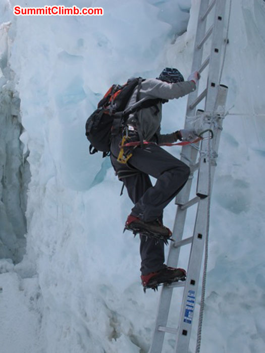 Thile Nuru Sherpa ascends a vertical ladder in the Khumbu Icefall. Monika Witkowska Photo