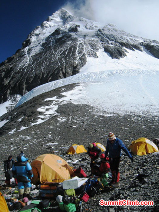 Mingma Sherpa, Jangbu Sherpa, Monika Witkowska, and Kieran Lally in the high camp at the South Col. Mt. Everest Summit in the background. Scott Smith Photo.