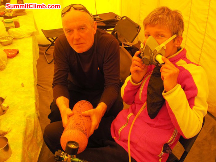 Kieran Lally and Monika Witkowska trying on the oxygen apparatus in basecamp. Scott Smith Photo.