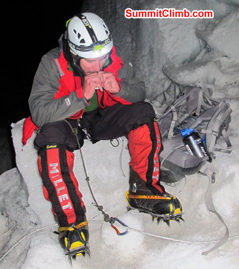 Slavomir Fila puts on his crampons at night at the 'crampon point' in the Khumbu icefall. Monika Witkowska Photo.