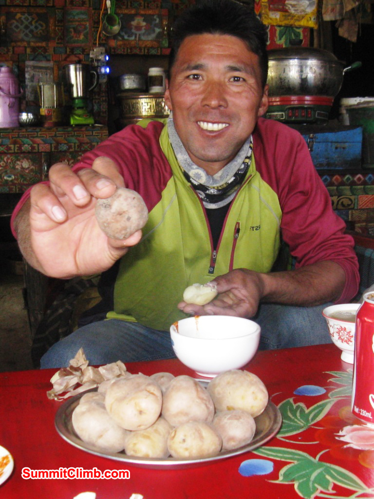 After checking all of that gear, a big plate of boiled potatoes being enjoyed by Tenji Sherpa = 10 Everest Summits!
