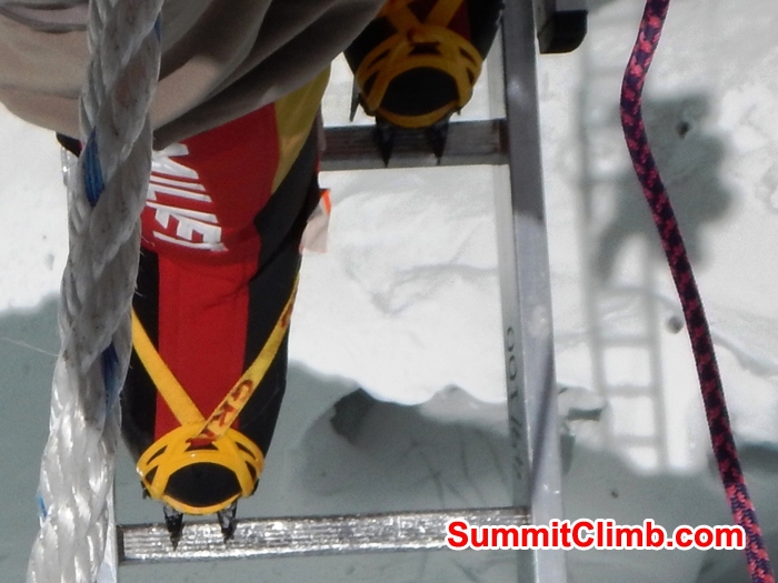 Mike Fairman crosses a ladder in the Khumbu Icefall.