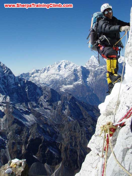 Gyelje Sherpa fixing rope in the lower part of the grey tower. Checkout camp two on top of the yellow tower in the lower left. photo by Maaike Braat
