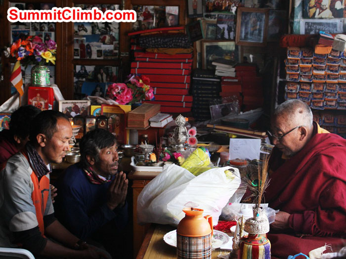 Thile Nuru Sherpa and Lakpa Kongle Sherpa being blessed by Lama Geshe. Photo by Sam Chappatte