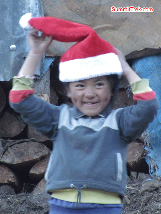 Small kid enjoying the christmas cap. Photo Aless