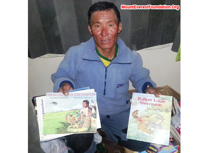 Jangbu Sherpa, Mount Everest Foundation, packing children's books for the service trek kindly donated by Carmen McMillan Nelon from Fort Worth, Texas. photo by Deha Shrestha. 