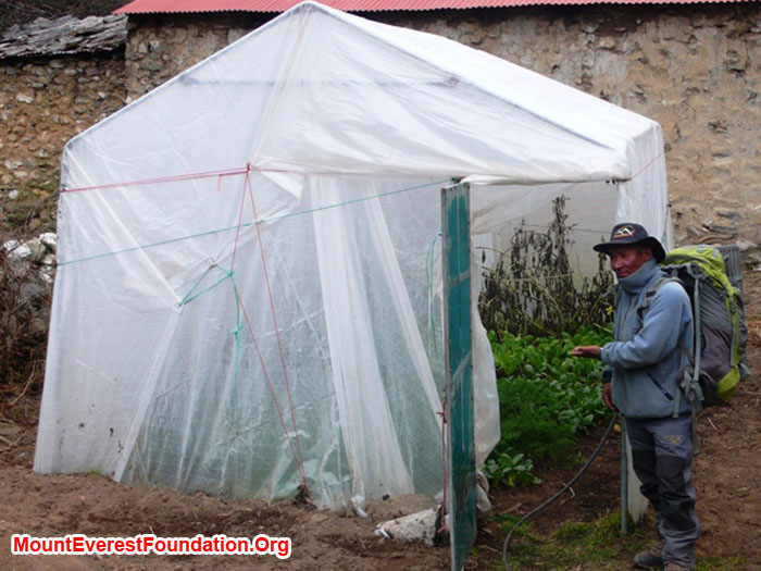 Jangbu Sherpa showing off the greenhouse, containing spinach, carrots, and tomatoes. Thanks to Marcia Macdonald and friends.