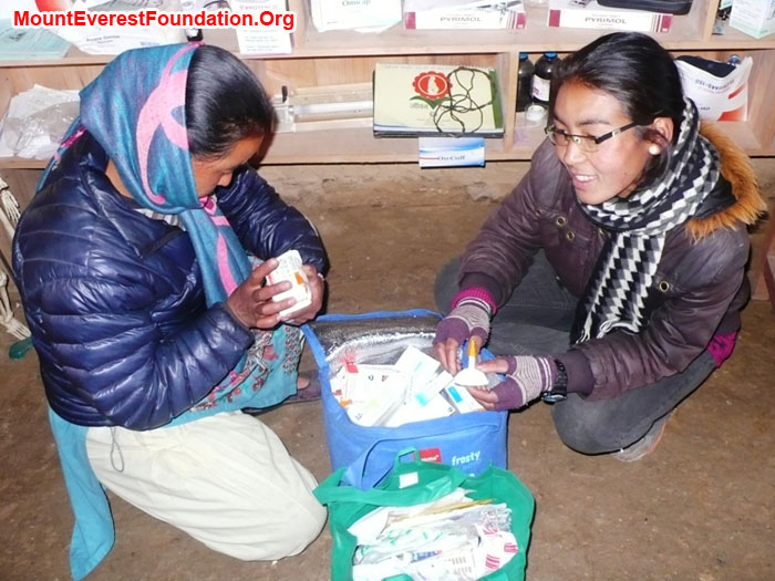 Pasi and Dati Sherpa examining medicines donated by Laurel and Paul Brophy and Paul Quinney from Mater Hospital, Rockhampton, Australia.